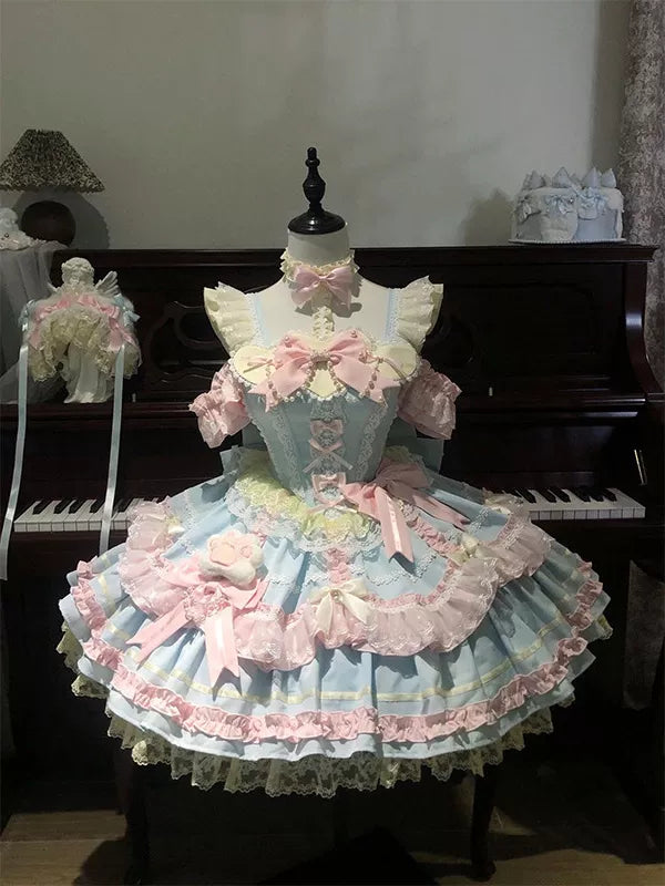 Creamy pastel blue and pink JSK dress set with layered ruffles and bows on a mannequin