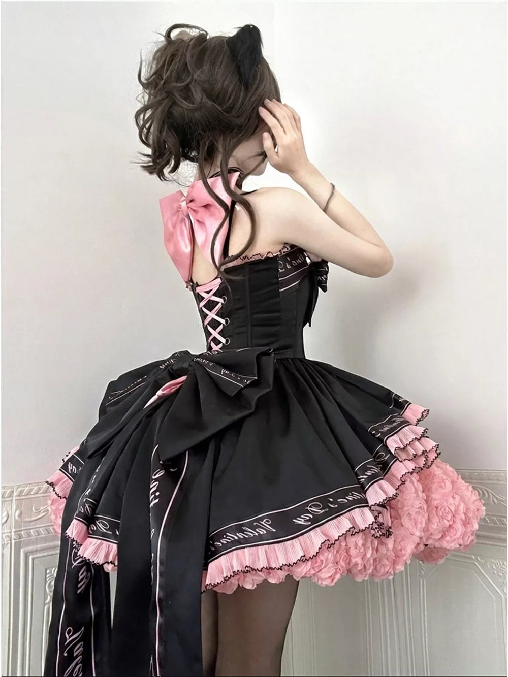Black-pink Lolita dress shown from front and back on a model.