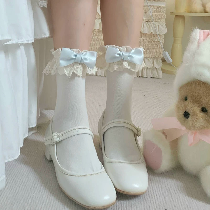 roji roji white short socks with white, blue, and pink bows shown flat