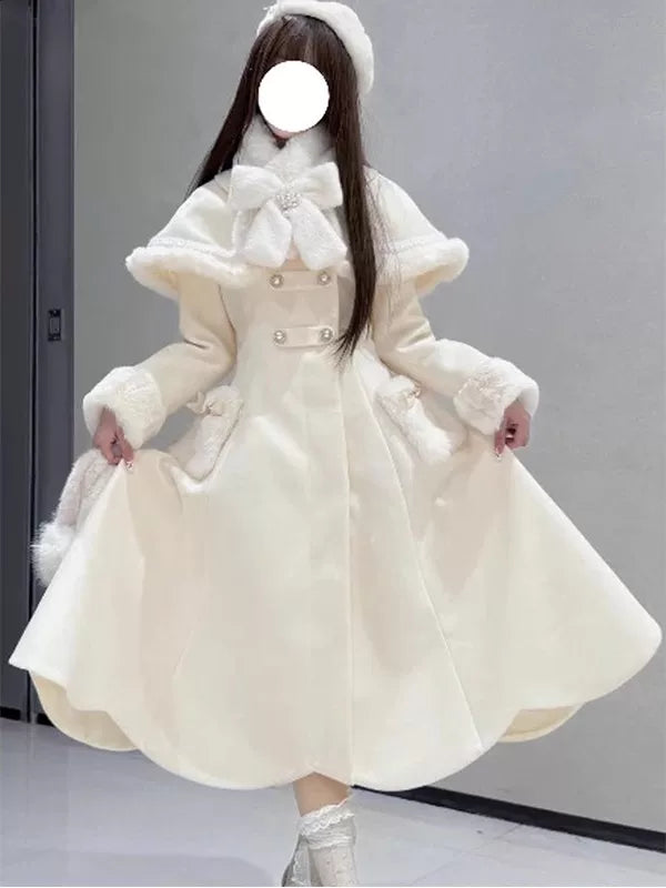 Milky-white cape dress coat with a large bow and plush trim shown on a model.