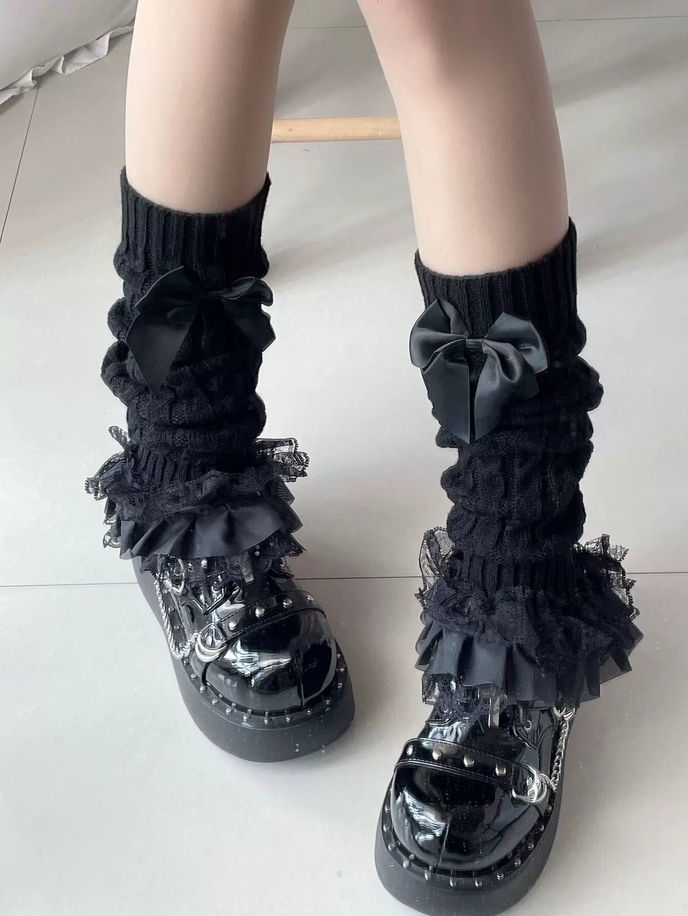 Fantasy Doll black knit slouch socks with lace ruffles and bow accents, shown in styling images.