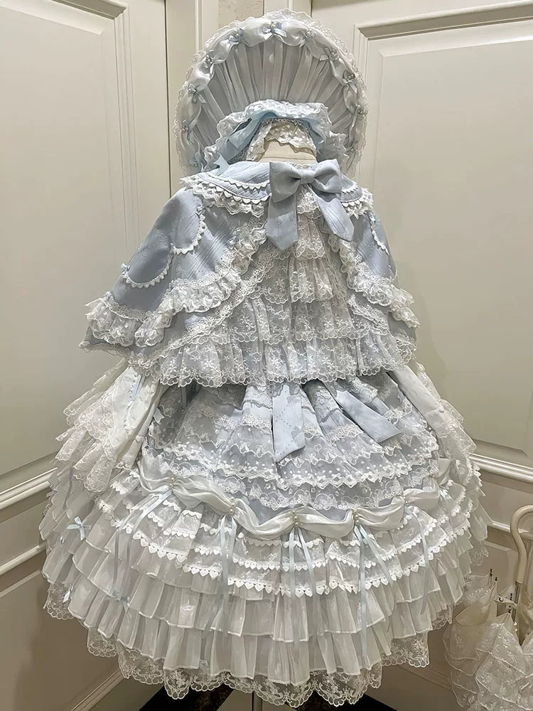 Blue Sweet Lolita JSK with attached hooded capelet, lace trim, and bow accents, front view