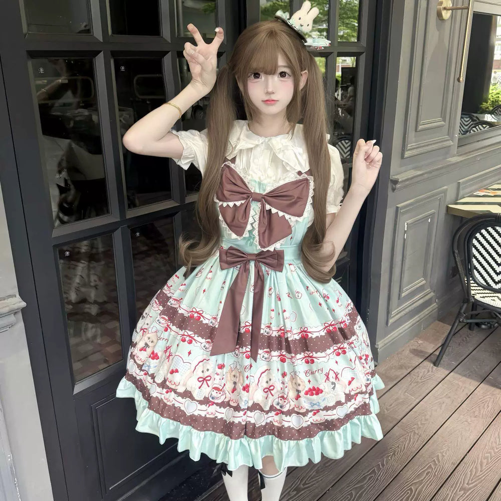 Mint and brown cherry-print JSK dress with oversized bows worn with a white blouse.
