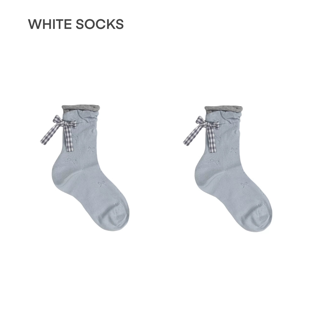 Pair of Sea Salt Blue mid-calf socks with rolled slouch cuffs, checked ribbon bows, and small bow motifs on a white background.