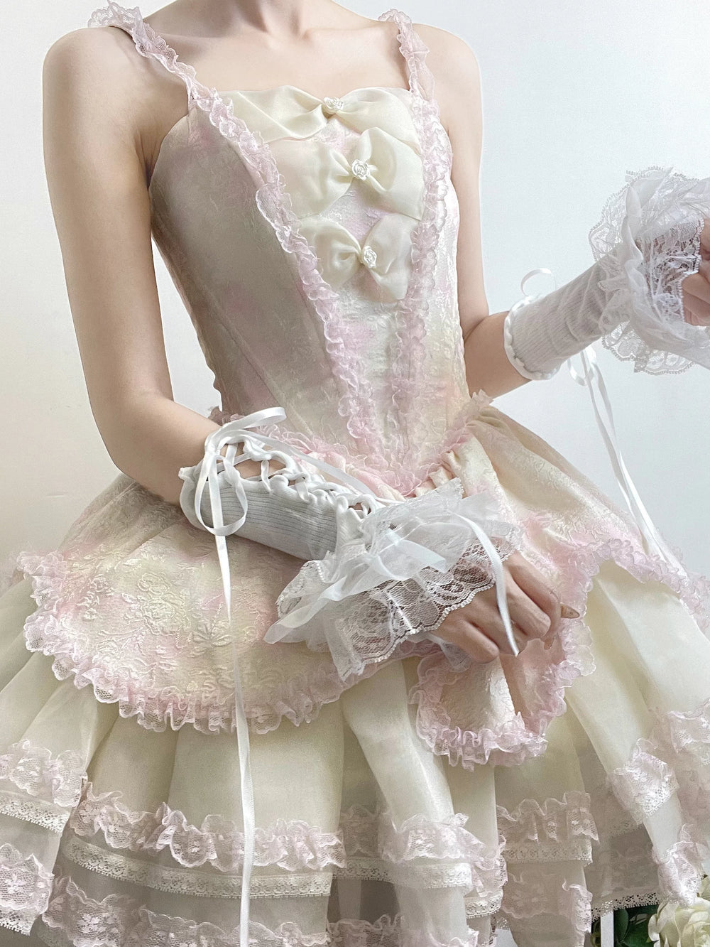 White lace-trimmed arm sleeves with ribbon ties and delicate ruffle details