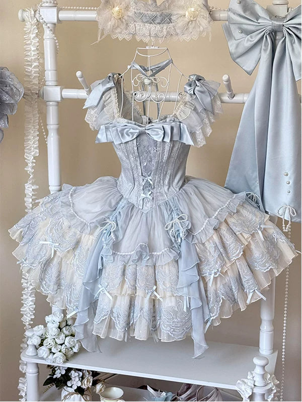 Front view of pale blue balletcore lolita JSK with swan embroidery, corset bodice, and bow accents