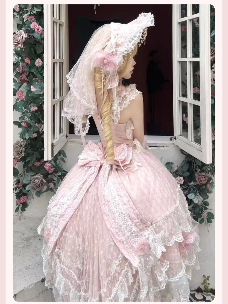 Gown detail showing sweetheart neckline, lace-trimmed puffed sleeves, and ribbon lacing on bodice