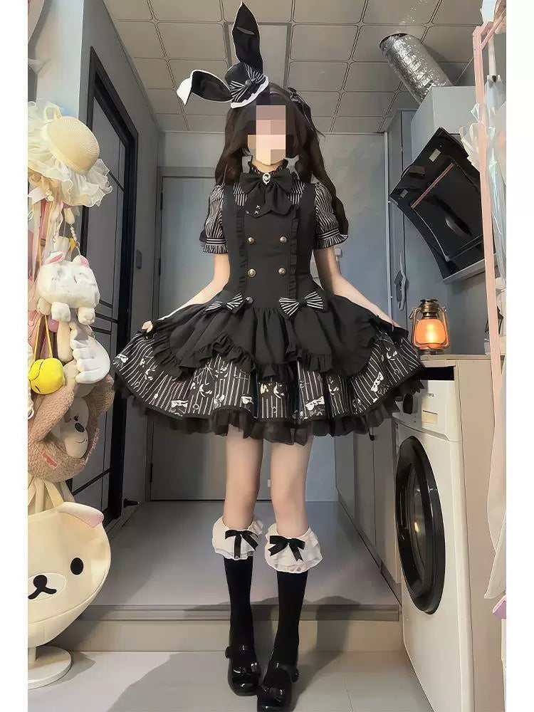 Black-and-white JSK with striped puff sleeves and a suspender skirt worn by a model.
