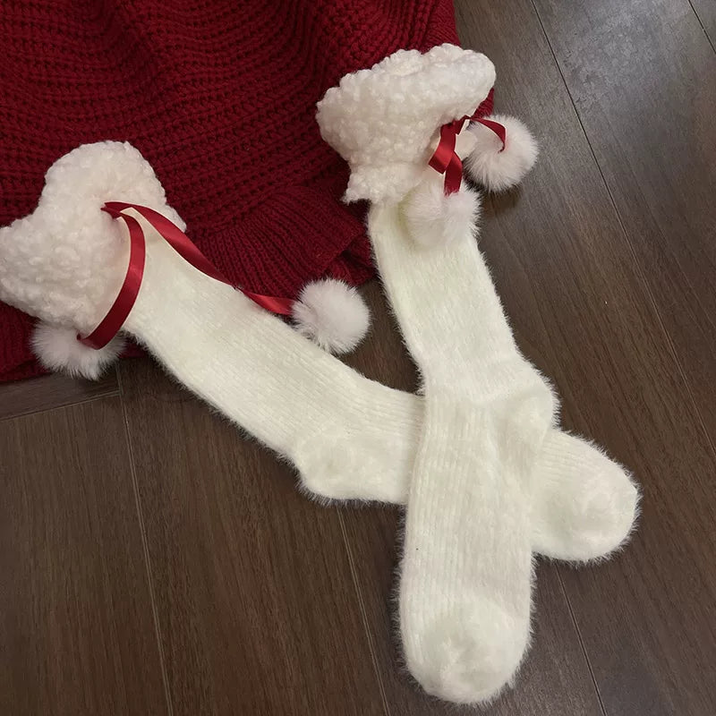 White mid-calf socks with fuzzy cuffs, red ribbon ties and pom-pom accents