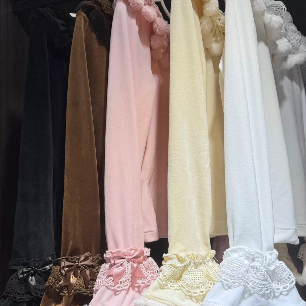 Long-sleeve ruffle-trimmed inner layer tops displayed on dress forms.