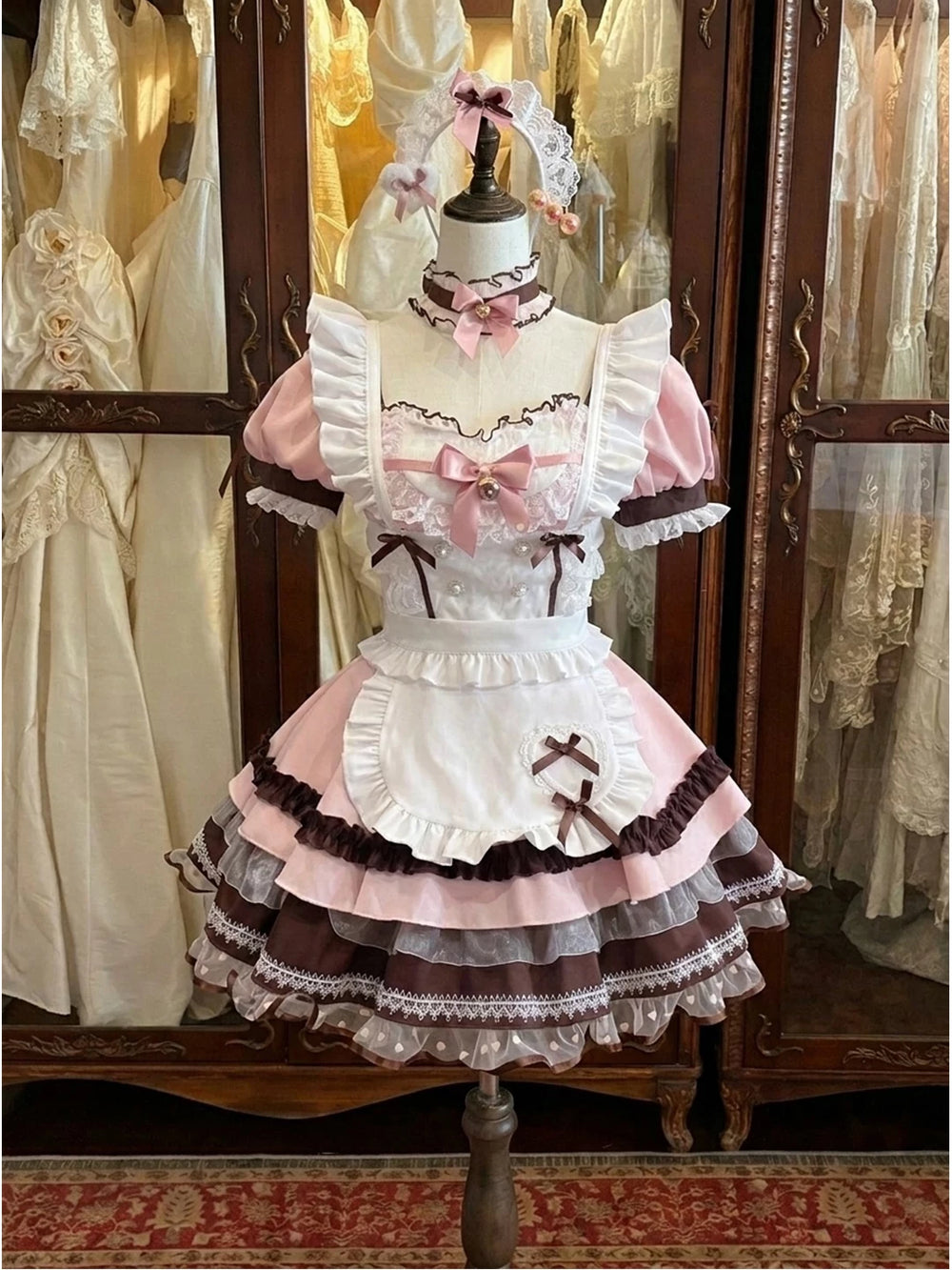 Creamy pink, white and brown OP dress set with ruffled apron on a mannequin