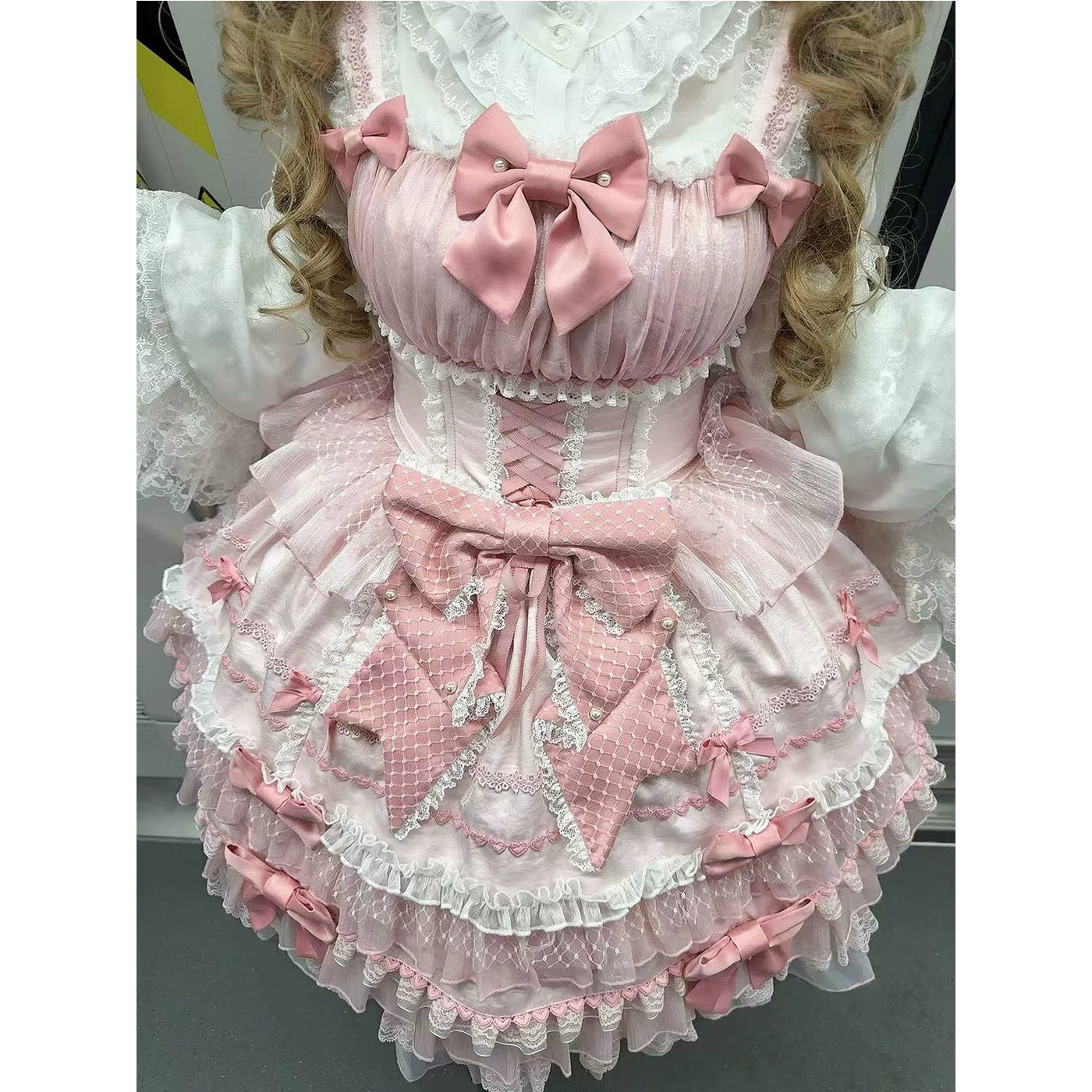 Creamy pink layered JSK with bows and lace worn in a full Lolita coordinate