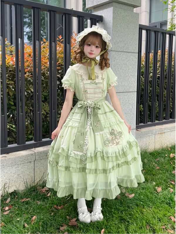 Pale green embroidered OP dress with lace collar and full skirt outdoors