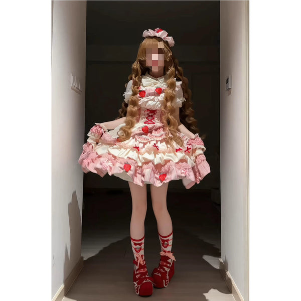 Pink strawberry Lolita JSK dress set with a white blouse shown on a model.