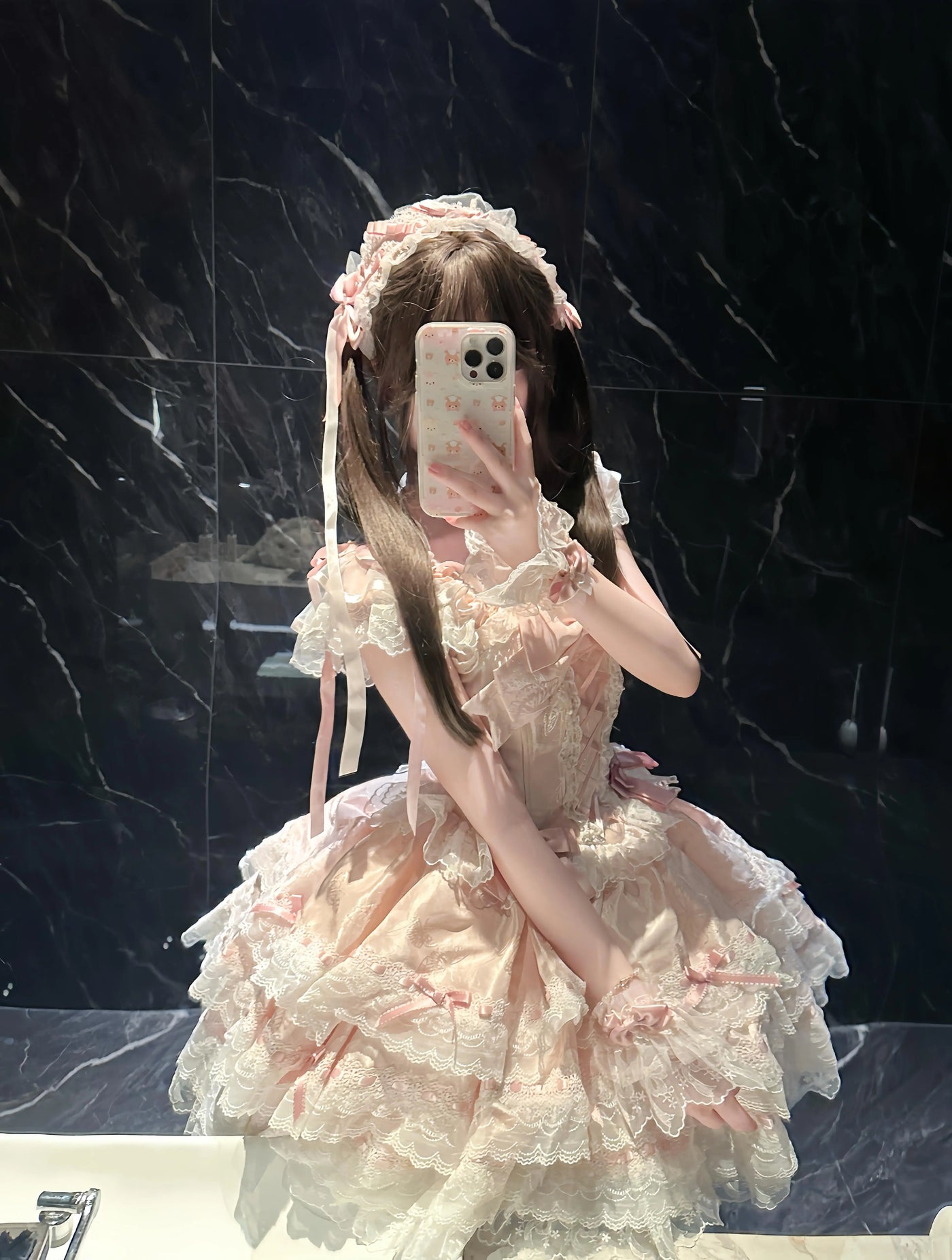 Pink bridal Lolita JSK dress with layered lace, bows, neck accessory and train shown in a mirror selfie.