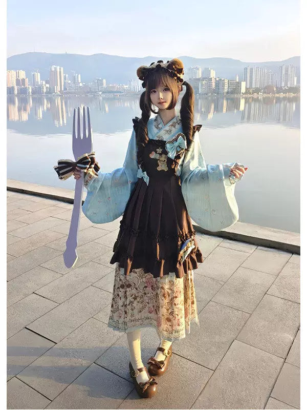 Model wearing a blue pipa-sleeve top with a coffee-brown embroidered overskirt and printed mamian skirt.