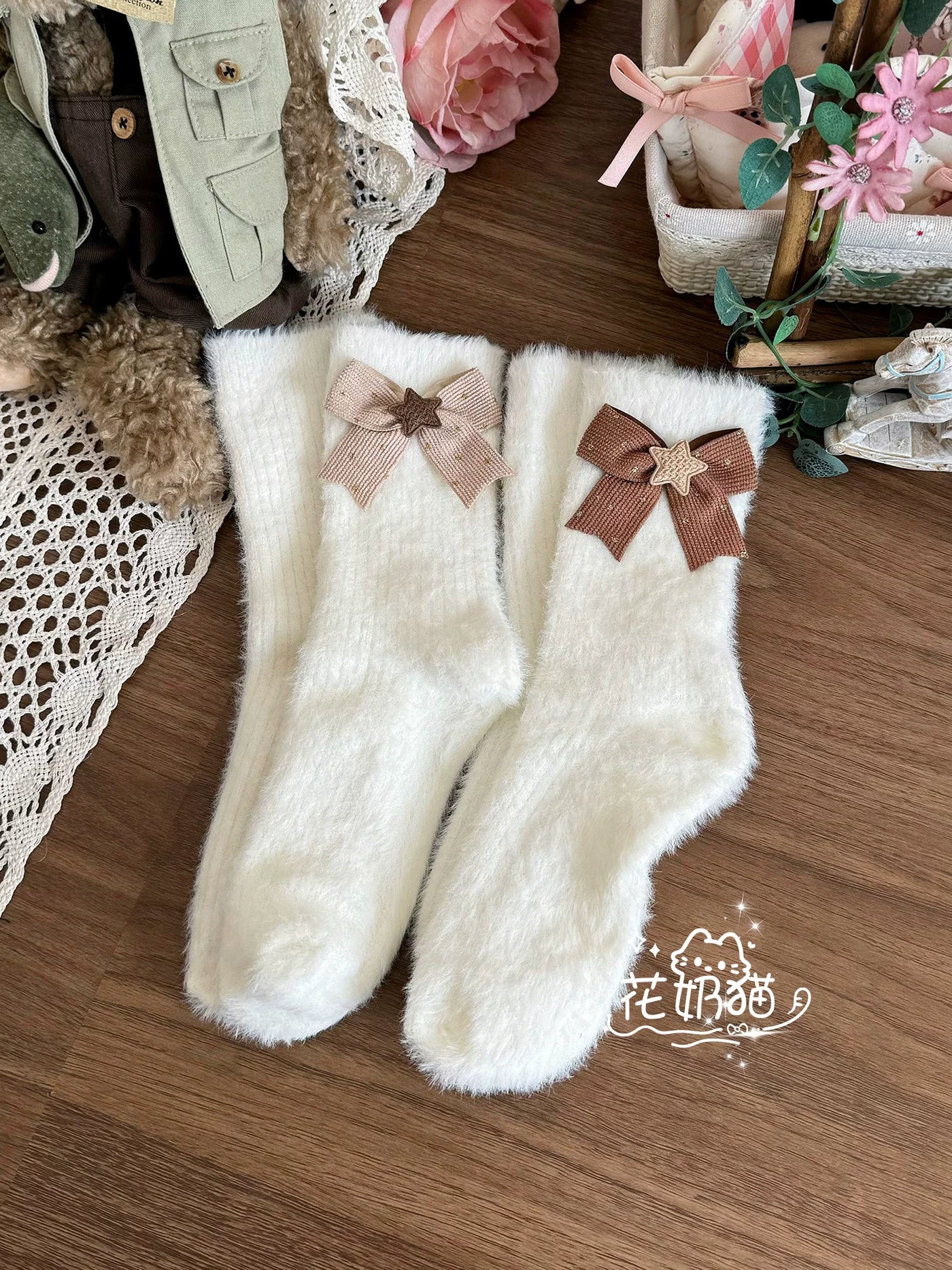 Pair of white plush mid-calf socks with bow and star details.