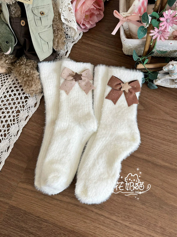 Pair of white plush mid-calf socks with bow and star details.