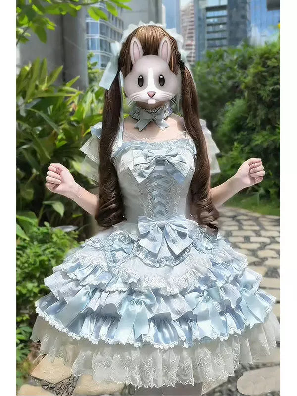 Model wearing a pale-blue layered Lolita dress set with bows and lace.