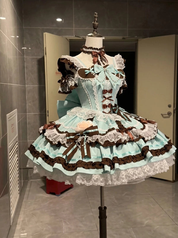 Creamy mint-and-brown JSK dress set with lace ruffles and ribbon bows on a mannequin