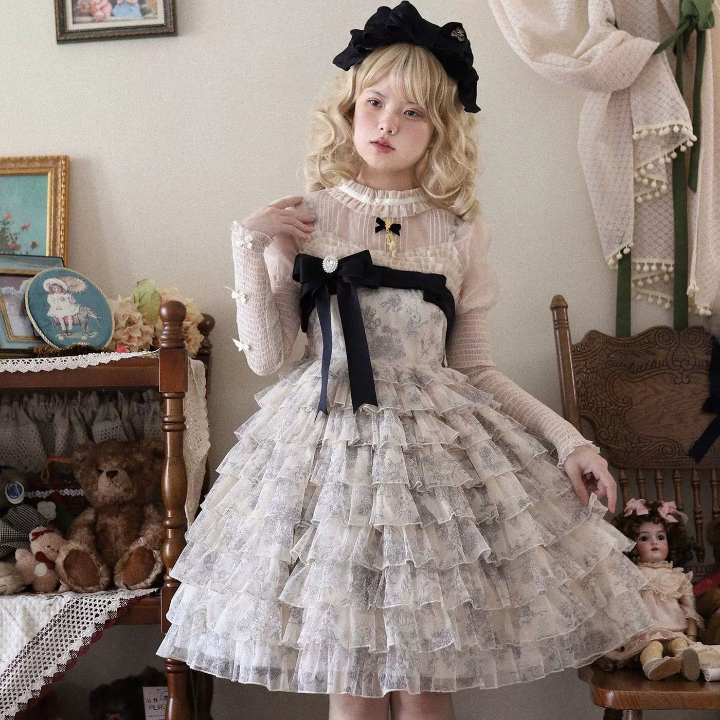 Pale tiered ruffle JSK with a broad black waist ribbon shown in styled Lolita portraits.