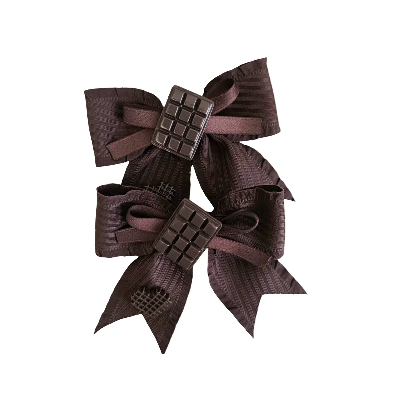 Two dark brown ribbon bows with rectangular chocolate-inspired centers on a white background.