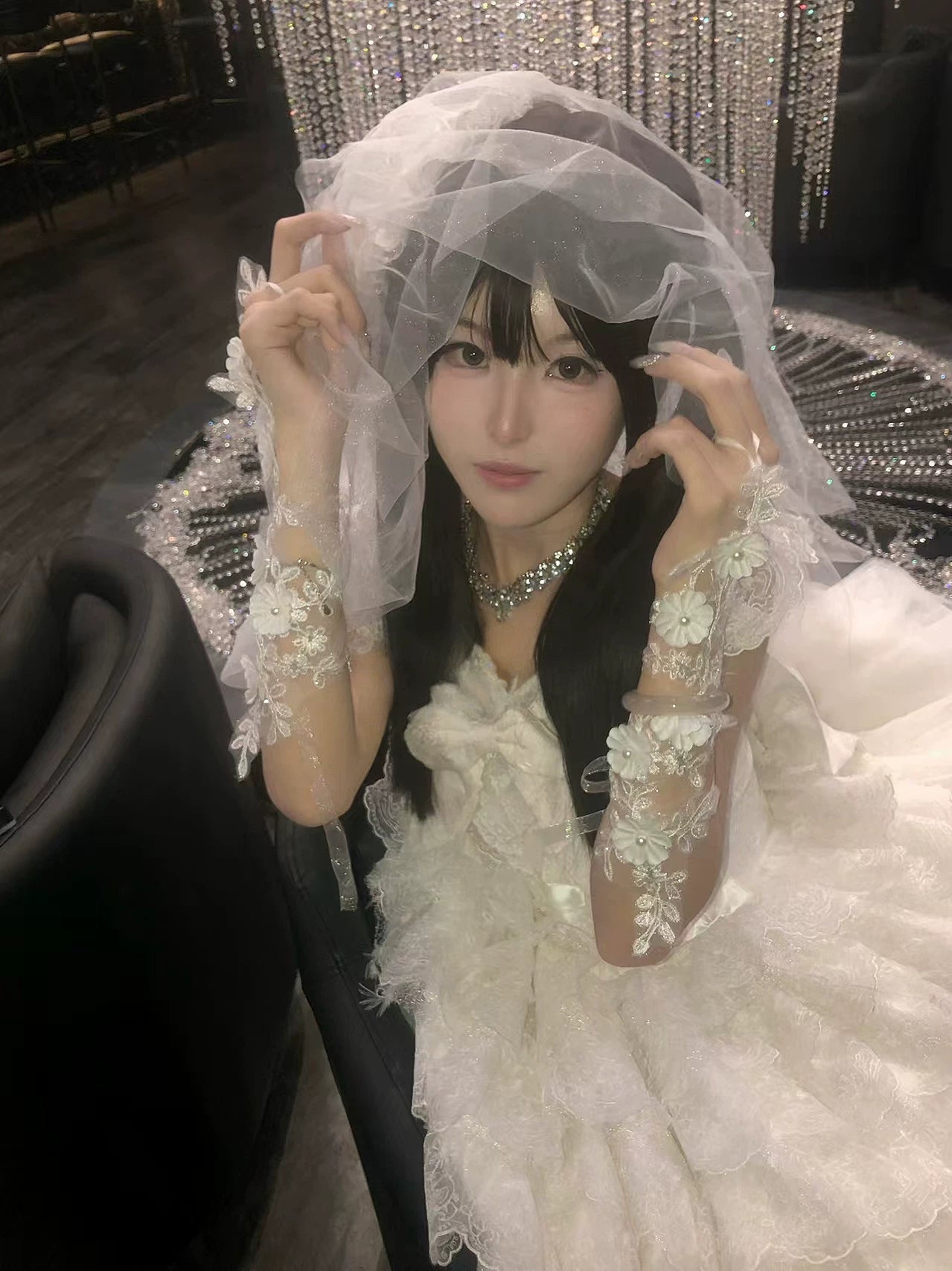 White floral lace hand sleeves worn with a white Lolita coordinate.
