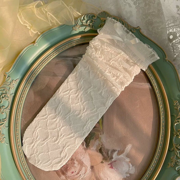 White lace mid-calf sock with ruffled cuff and small bow