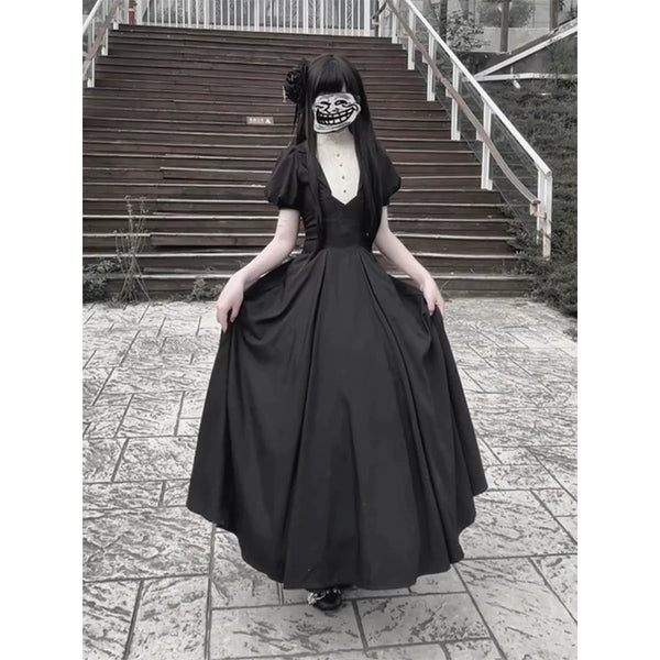 Model wearing a black vintage Gothic one-piece dress with a white inset front and long full skirt