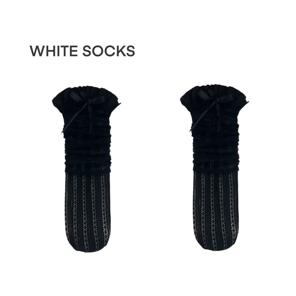 Black lace mid-calf socks with gathered cuffs and bow details styled with black heels.