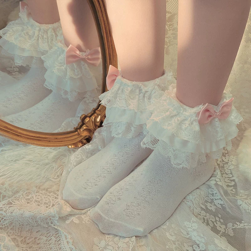 White lace slouch socks with layered ruffle cuffs and pink bows
