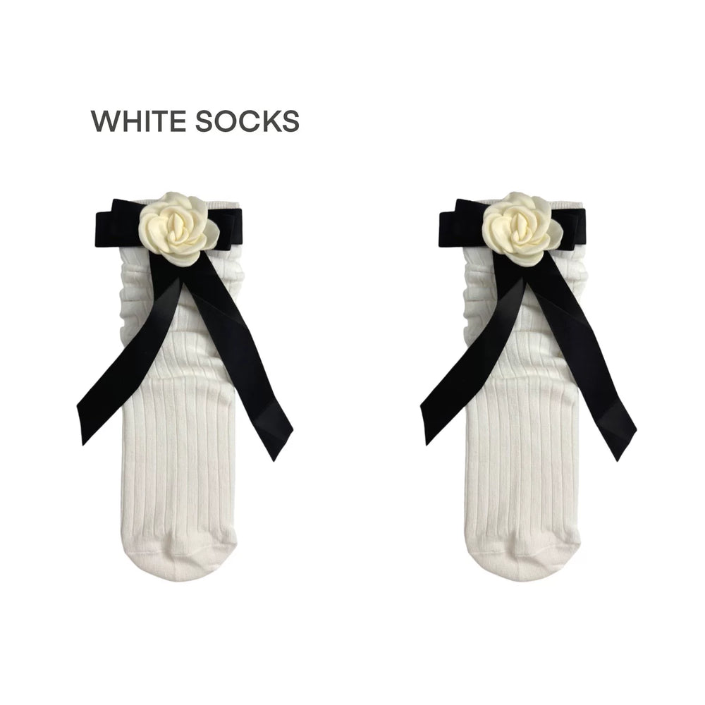 White ribbed calf socks with a rose and black ribbon bow