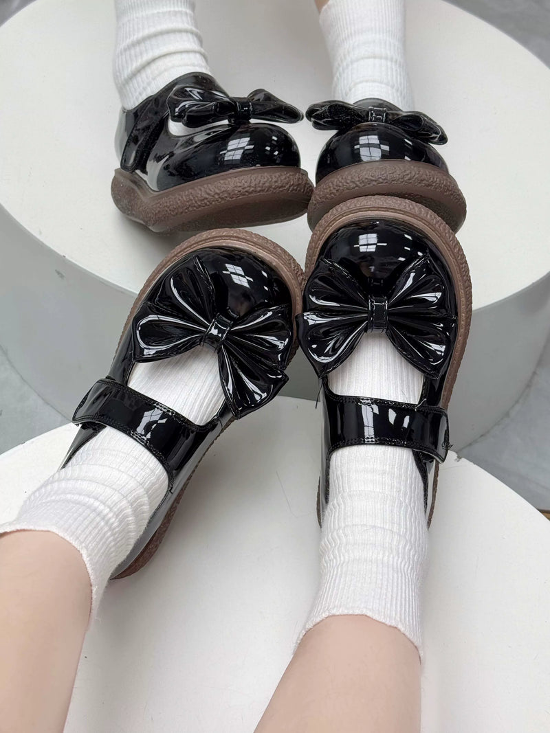 Black QQ Candy Mary Jane shoes with oversized toe bows