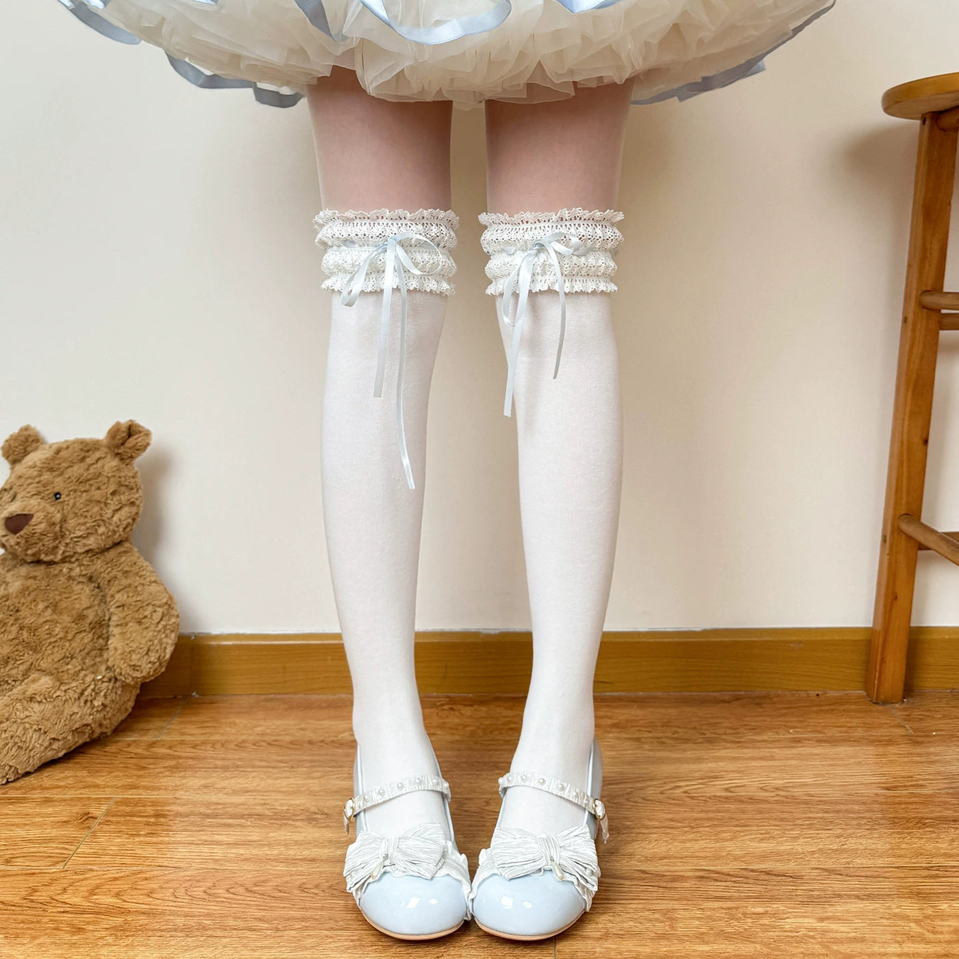 Black over-the-knee socks with black ribbon and lace trim