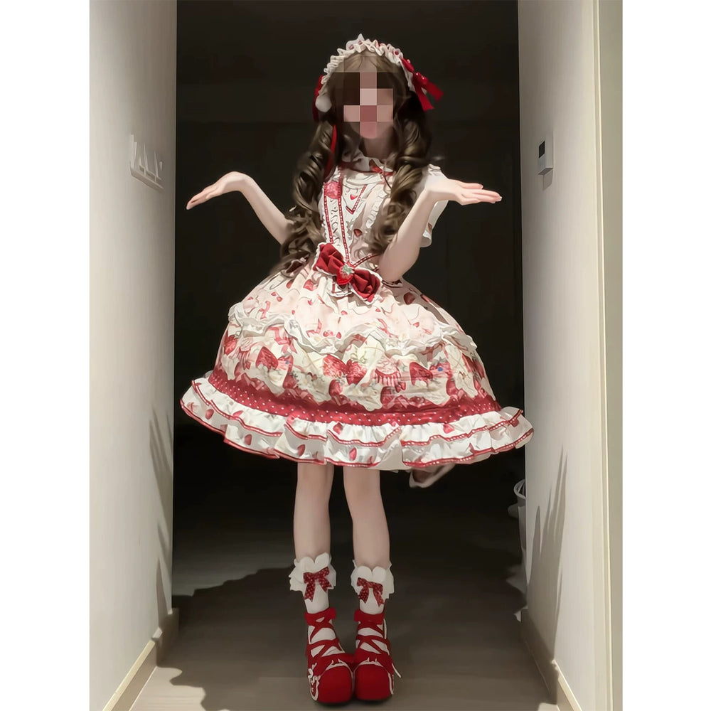 Pink-and-red strawberry JSK with red ribbons, full skirt and matching accessories worn by a model.