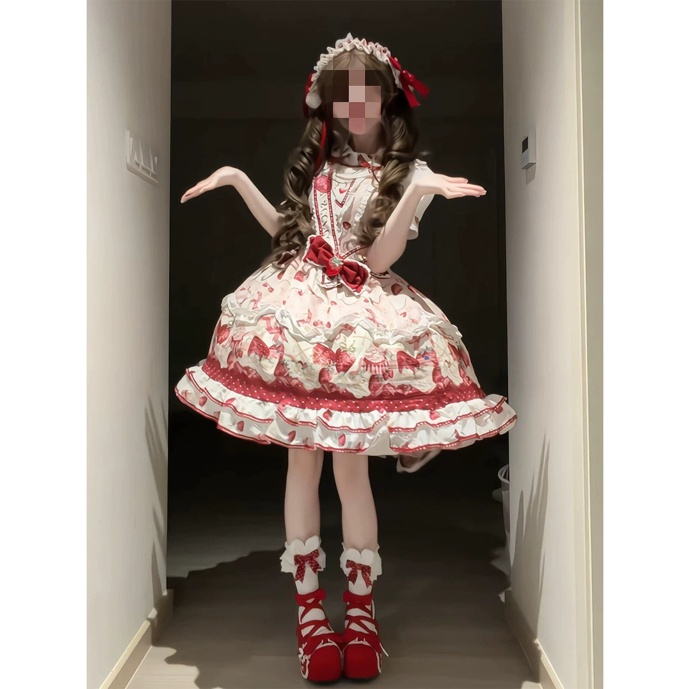 Pink-and-red strawberry JSK with red ribbons, full skirt and matching accessories worn by a model.