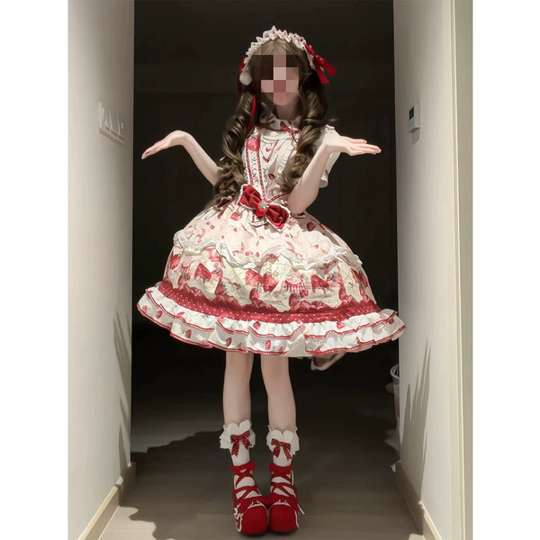 Pink-and-red strawberry JSK with red ribbons, full skirt and matching accessories worn by a model.