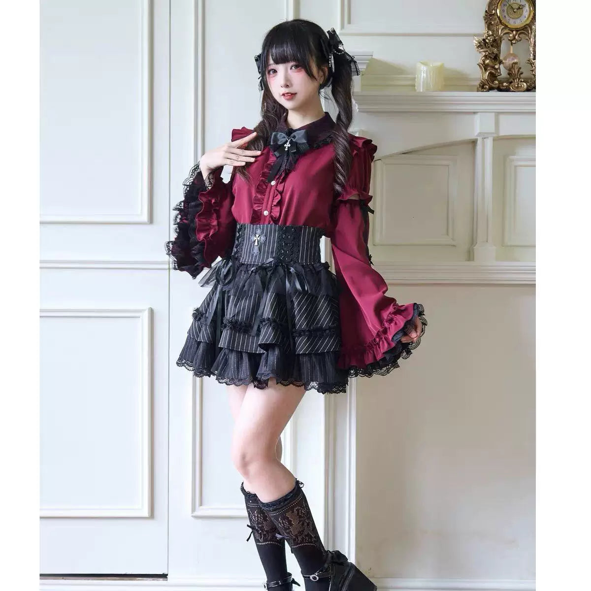 Black and white Gothic Lolita blouses with bow necklines and princess sleeves styled with striped skirts.