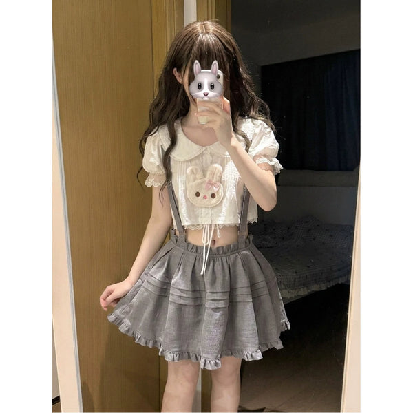 Cream top with rabbit detail and gray suspender puffy skirt three-piece outfit