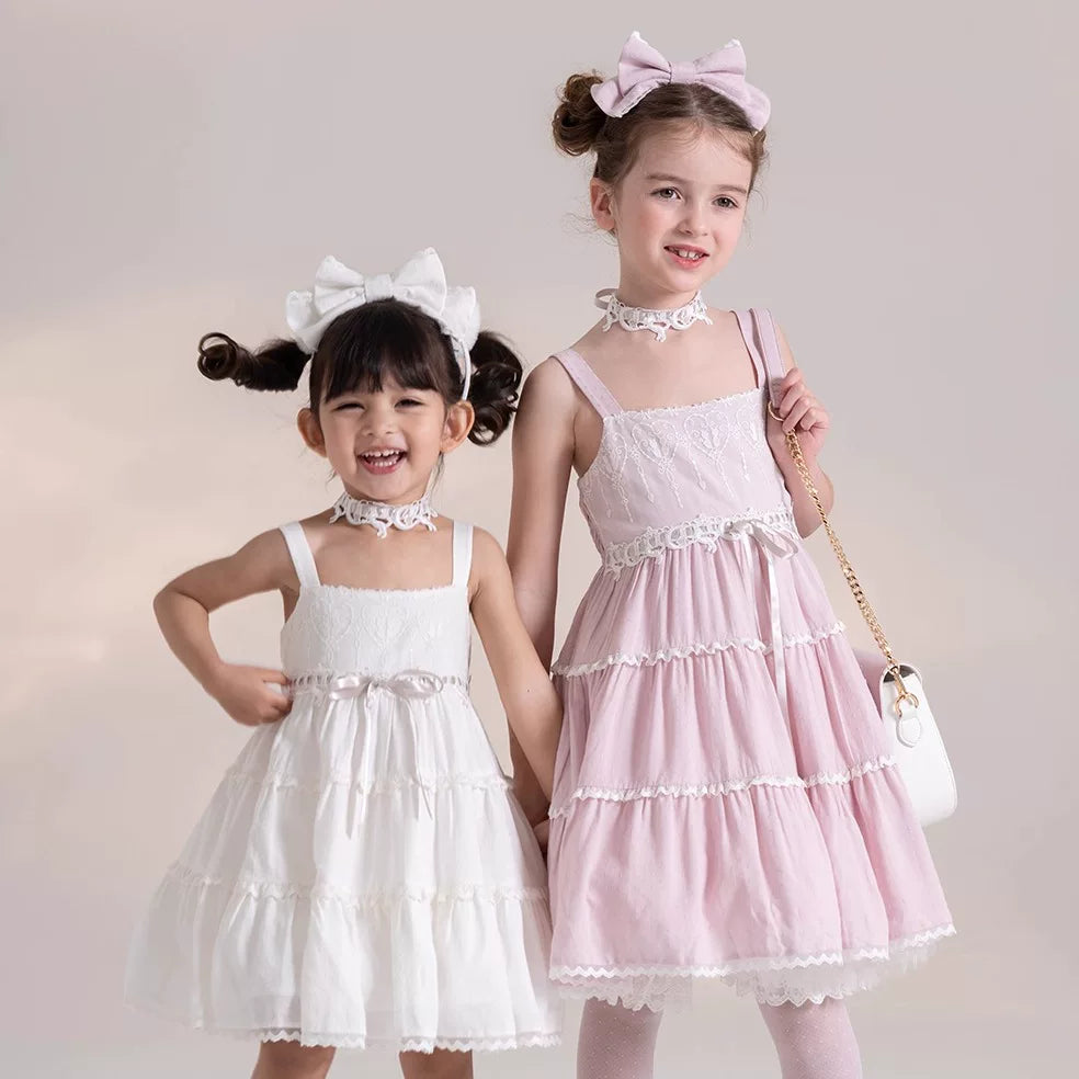 Krad Lanrete children's white and pink JSK dresses with tiered ruffles and lace trim.
