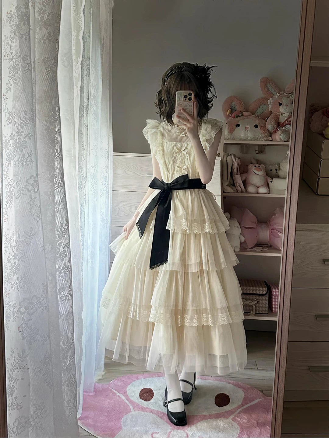 Cream tiered lace OP dress with black waist belt shown in a full-length mirror styling photograph.