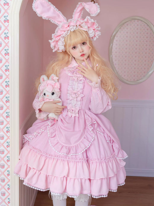 Pink-purple ruffled Lolita dress with white lace sleeves and bows displayed against a pink background.