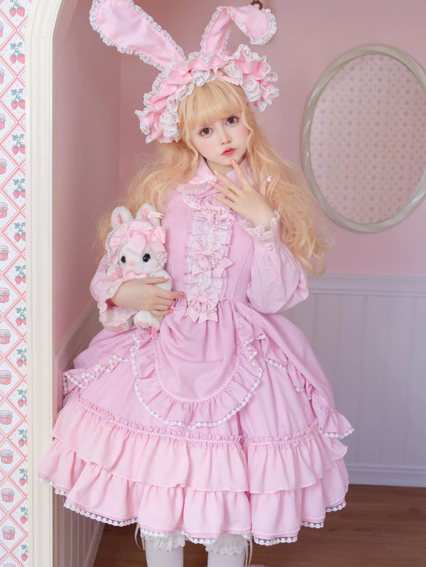 Pink-purple ruffled Lolita dress with white lace sleeves and bows displayed against a pink background.