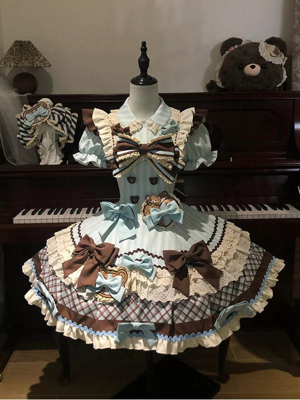 Creamy mint-and-chocolate bear one-piece dress with bows, lace trim, and checked skirt displayed on a mannequin