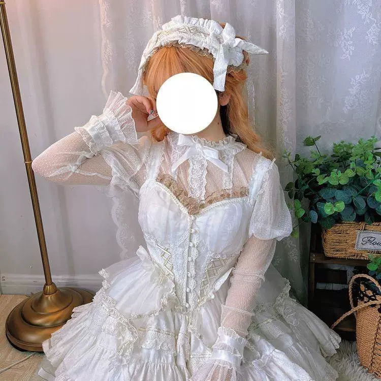 Model wearing a white long-sleeve lace mesh inner top with a ruffled neckline and lace cuffs.