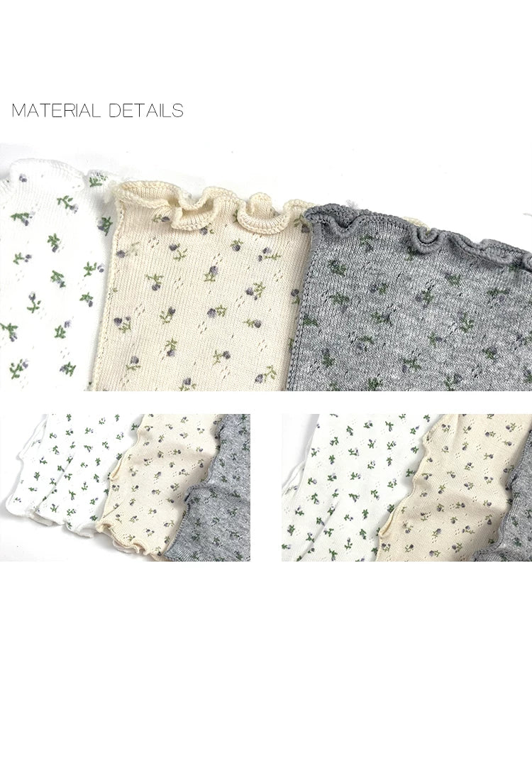 Floral mid-calf slouch socks in white, apricot and grey shown in a styled view