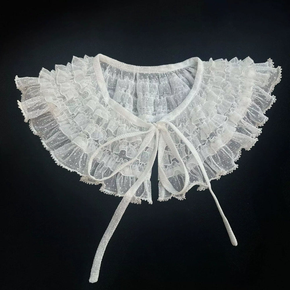 Ruffled dotted-tulle false collar with layered lace and ribbon ties.