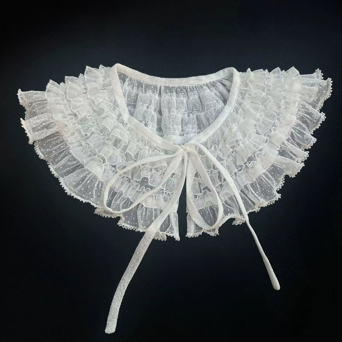 Ruffled dotted-tulle false collar with layered lace and ribbon ties.
