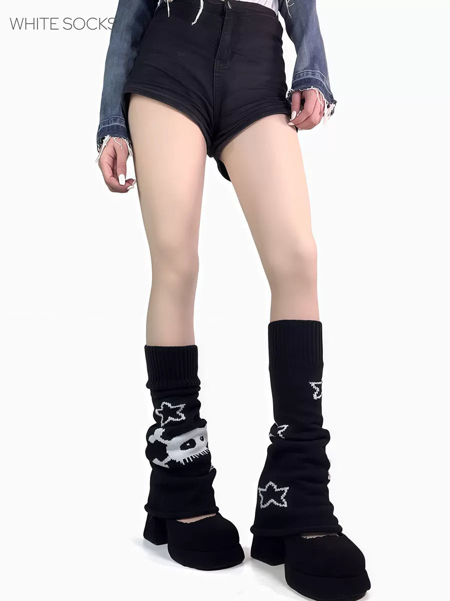 Black knitted leg warmers with white star graphics and flared openings