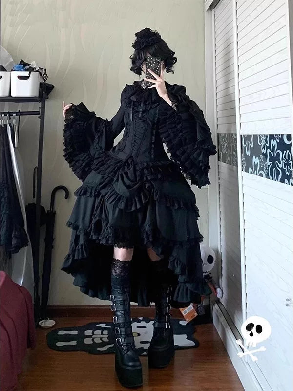Full-length mirror image of a black Gothic Lolita blouse and underskirt set with ruffled princess sleeves.